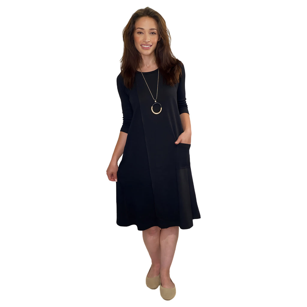Woman wearing a black dress with a white background