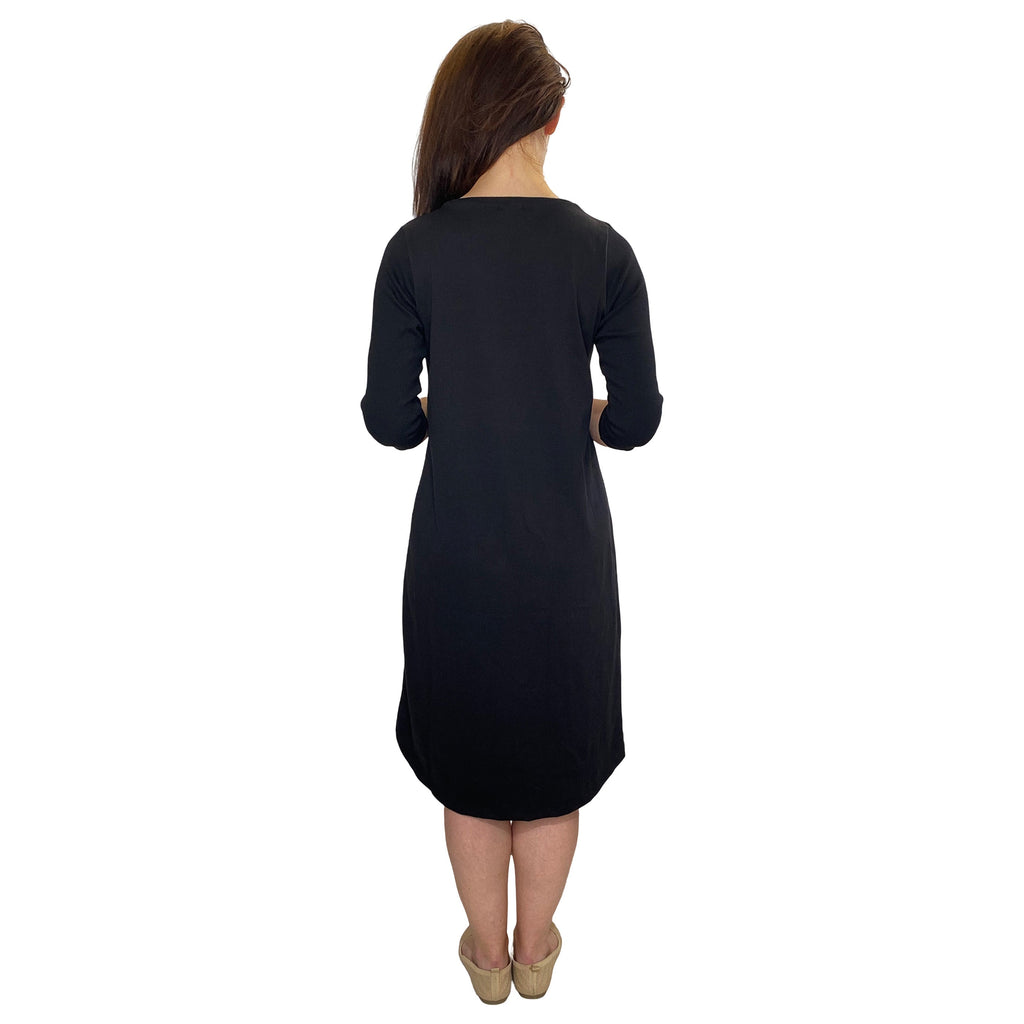 Woman wearing a black dress on a white background
