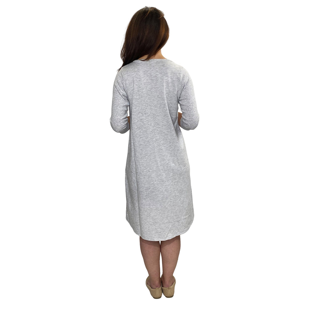 Woman wearing a gray dress on a white background