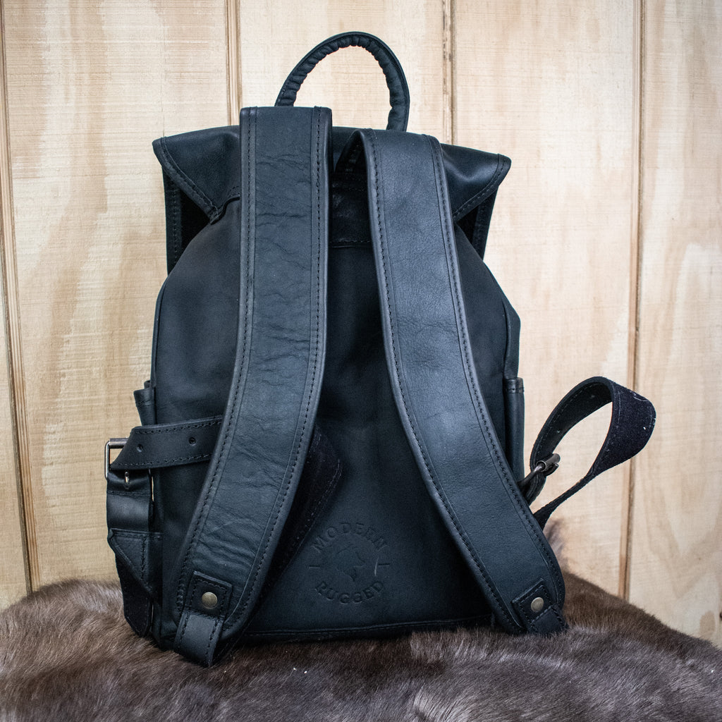 Black backpack on a wooden surface