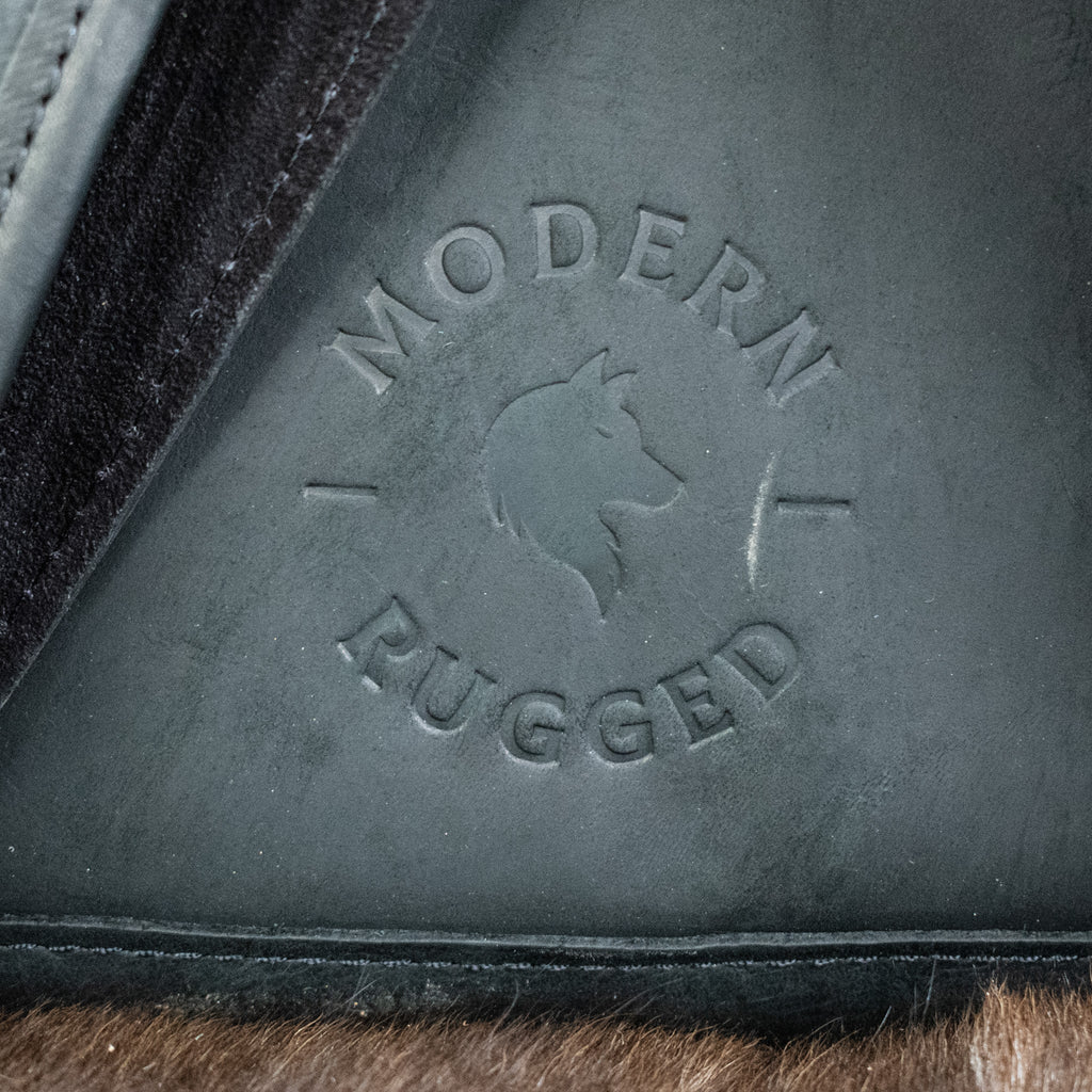 Close-up of 'Modern Pugged' logo on a product with fur texture.