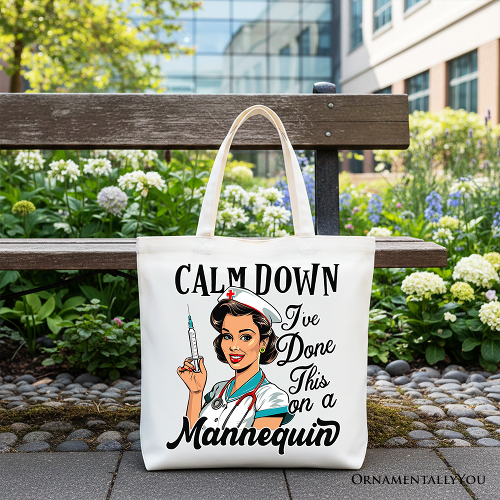 Tote bag with a nurse graphic and text 'Calm Down I've Done This on a Mannequin' on a bench outdoors.