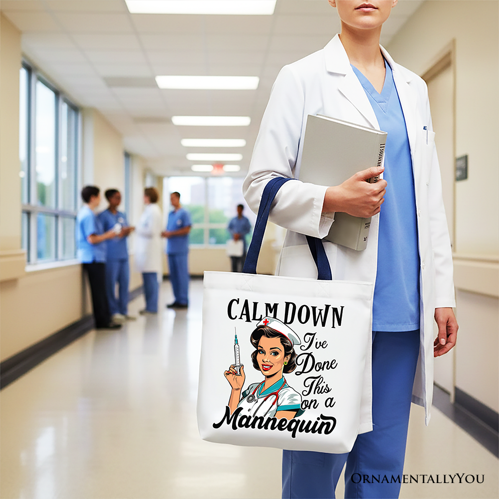 Person in medical scrubs holding a tote bag with a humorous design in a hospital setting
