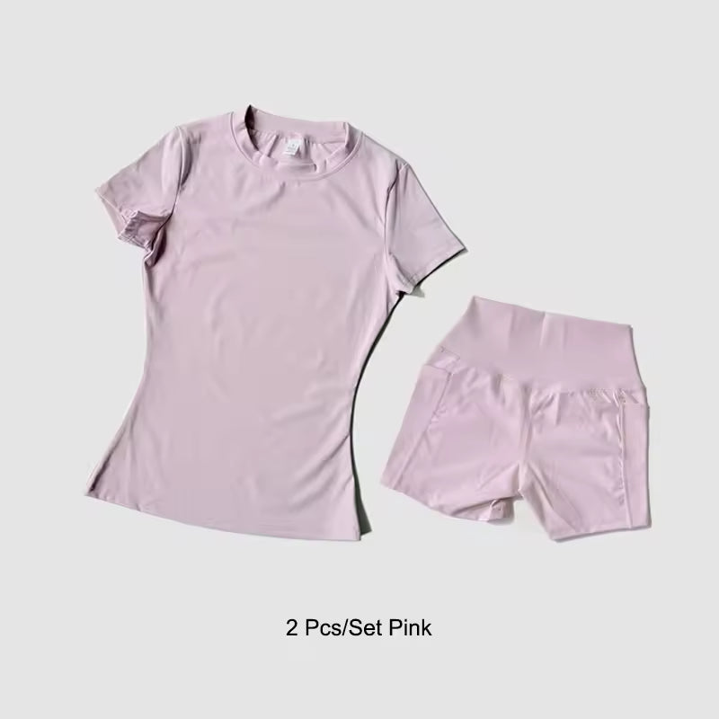 Pink t-shirt and shorts set on a light gray background