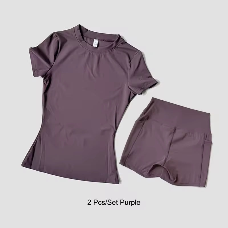 Purple t-shirt and shorts set on a light gray background