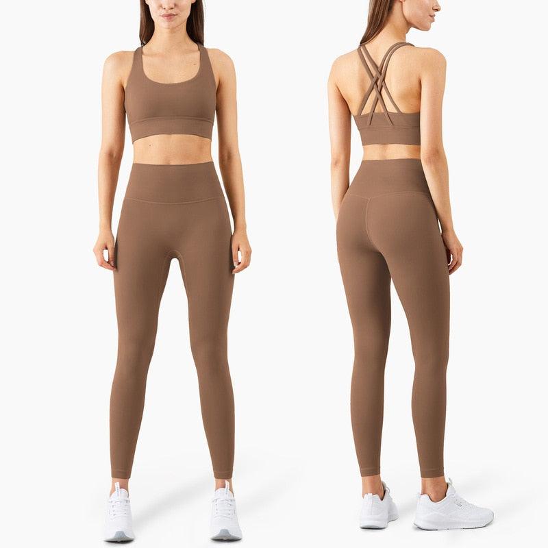 Brown athletic outfit with sports bra and leggings on a white background