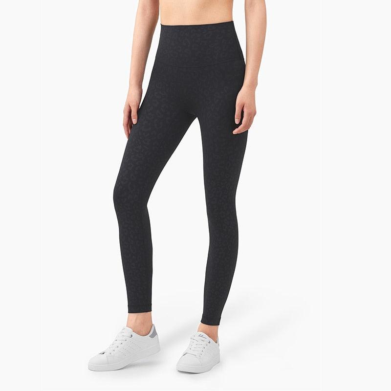 Person wearing black leggings on a white background