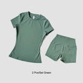 Green t-shirt and shorts set on a light gray background
