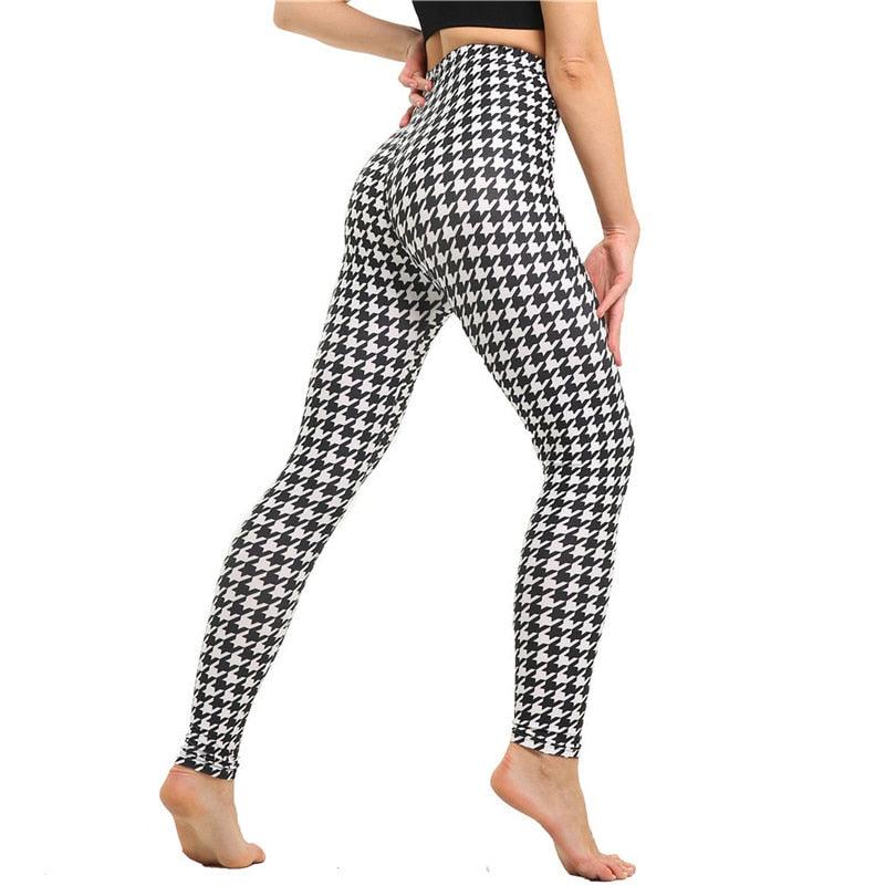 Houndstooth patterned leggings worn by a person on a white background