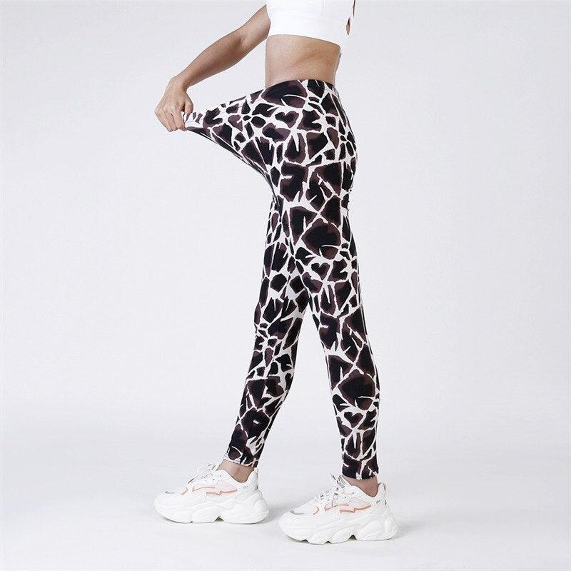 Person wearing black and white patterned leggings on a white background
