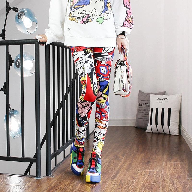 Person wearing colorful pants and shoes in a room with a black metal railing and light fixtures.